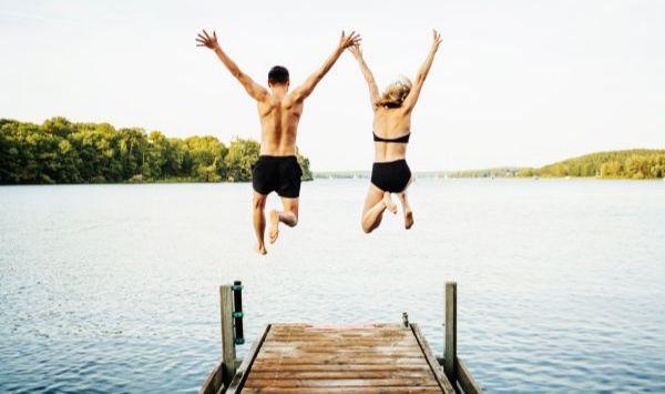 Couple jumping in lake. Couple jumping in lake.